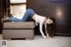 A woman laying on top of a couch in a room.