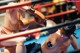 Two female boxers fighting in a boxing ring. 