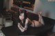 A woman in a black lingerie laying on a table.