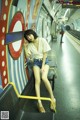 A woman sitting on a bench in a subway station.